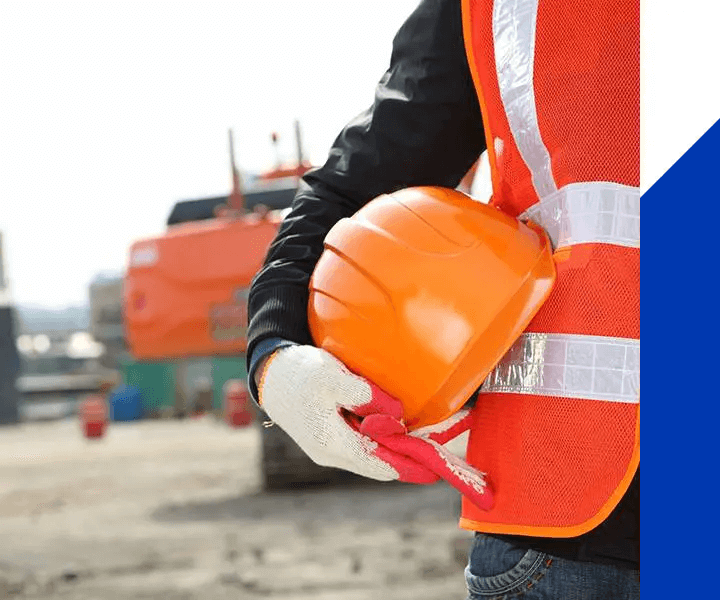 A man holding an orange construction helmet